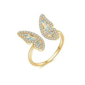 Elegant gold butterfly ring with zircon stones and blue enamel details on white backdrop