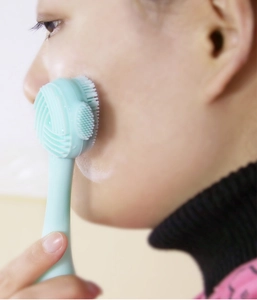 Close-up of a blue silicone face brush used for gentle skin cleansing and massage