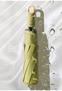 Macro shot of olive green folding umbrella with ring handle and UPF50+ waterproof fabric