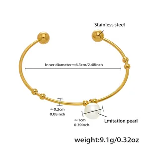 Detailed view of golden stainless steel open bangle with imitation pearl and beads