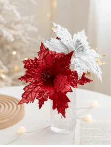 Close-up of red and silver glitter poinsettia flowers in a frosted glass vase