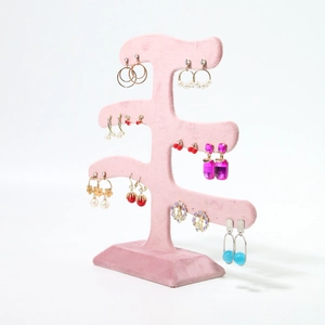Pink velvet tree-style earring display stand for jewelry storage on white background