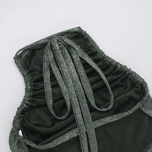 Detailed macro view of dark green shimmer fabric with silver glitter and drawstring ties