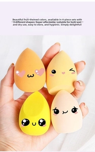 Set of four ultra-soft makeup sponges in various fruit colors and shapes held by hand