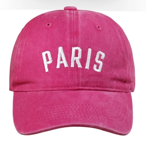 Close-up of vintage washed cotton baseball cap with white Paris embroidery in rose pink
