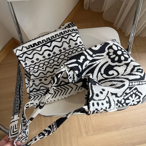 Close-up of Bohemian linen shoulder bag with tribal geometric patterns on a chair