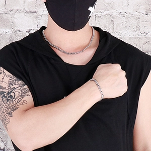 Close-up of hip hop silver cuban link chain necklace and bracelet set on male model