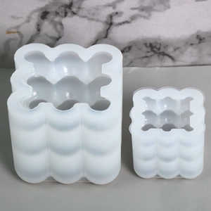 Macro view of white bubble cube silicone candle molds in two different sizes