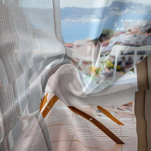 Detail of Mediterranean landscape printed on lightweight semi-sheer polyester curtain