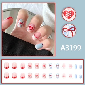 Short square press-on nails with blue checkerboard, red bows, and heart patterns