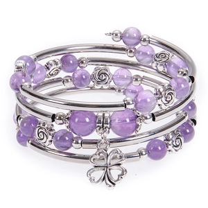 Macro detail of multi-layer beaded bracelet with purple stone beads and clover charm
