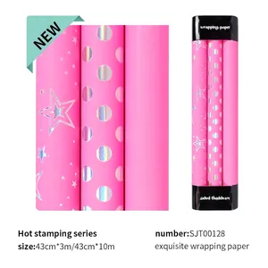 Pink wrapping paper roll with holographic gold foil stars and dots for birthdays