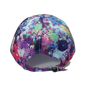 Detail view of the metal adjustable buckle on a colorful splatter graffiti baseball cap