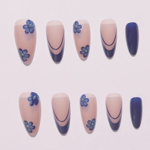 Blue floral press-on nails set with stiletto shape and French tips on white background
