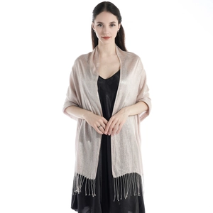 Close-up of light pink glitter shawl featuring metallic texture and fringe details