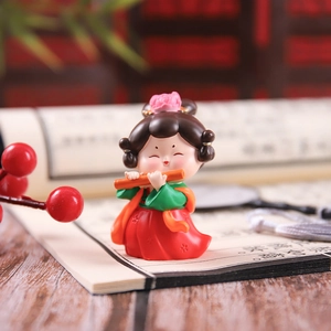Detailed close-up of a Tang Dynasty style figurine girl playing a flute decor
