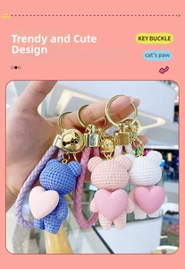 Detail of woven texture resin heart bear keychains with gold bells and leather straps