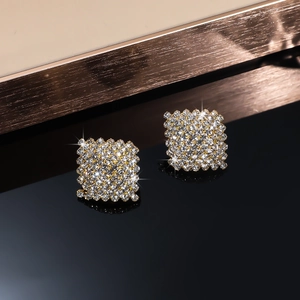 Detailed view of square geometric stud earrings with full pavé cubic zirconia setting