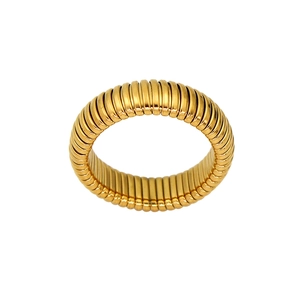 Macro shot of gold-plated titanium steel ring with vintage Tubogas spiral texture