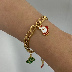 Close-up of a gold stainless steel Christmas bracelet with Santa and tree charms