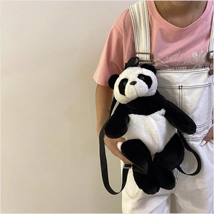 Detail of creative plush giant panda backpack with soft fur and adjustable black straps