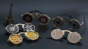 Detail of steampunk flip-up sunglasses with metal frames and intricate gear designs