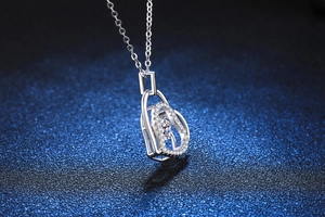 Close-up of heart pendant with dancing moissanite center and pave-set accents