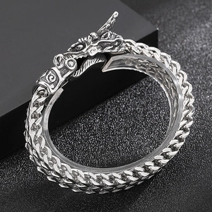 Close-up of polished stainless steel dragon head clasp and braided dragon bone chain