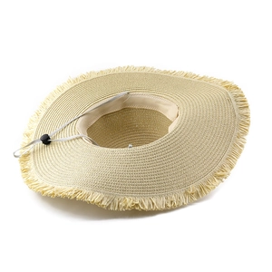 Detailed macro view of the straw hat with frayed edges and adjustable chin strap