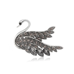 Detailed view of a retro silver swan brooch with dark marcasite and teardrop stones