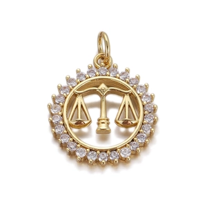 Close-up of gold-plated circular pendant featuring a balance scale and zircon inlay