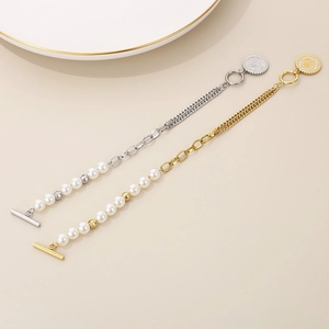 Detail of 18K gold and silver plated pearl link chain bracelets with coin charms