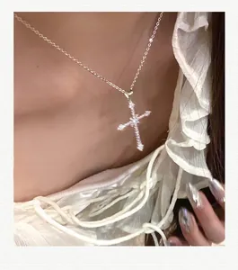 Close-up of star cross pendant with sparkling zircons on elegant silver chain for women