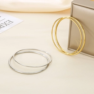 Minimalist 2mm stackable 18k gold plated stainless steel bangles in gold and silver