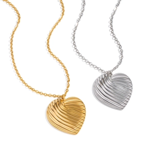 Textured gold and silver heart pendant necklaces on fine cable chains with a 3D wave pattern