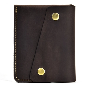 Detail of dark brown crazy horse leather wallet with yellow stitching and gold snaps