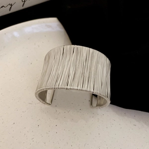 Minimalist wide silver wire-wrapped cuff bracelet for women with open industrial design