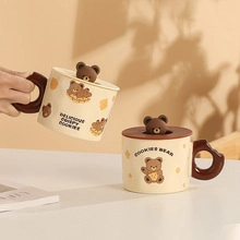 Close-up of cute ceramic bear mug with 3D lid decoration in a warm home setting