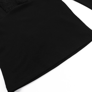 Close-up of black lace hem detailing on a deep V-neck long sleeve knit top