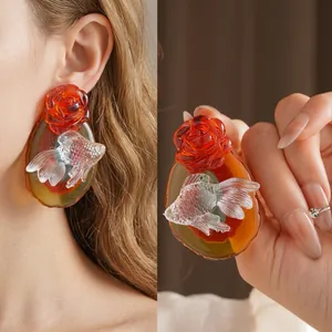 Oriental style earrings with red rose and translucent goldfish relief in amber resin