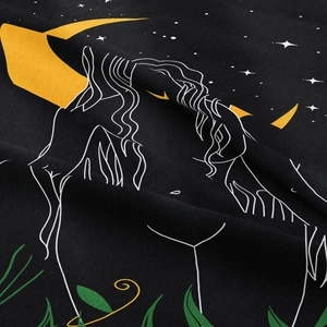 Detail of bohemian tapestry fabric showing artistic female profile with moon and stars