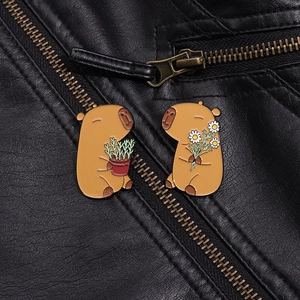 Close-up of capybara enamel pins with flower and plant on a black leather jacket