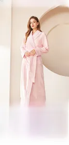 Detailed texture of pink flannel bathrobe featuring waffle trim on collar and sleeves