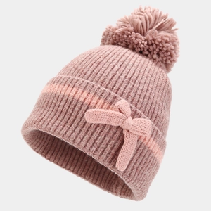 Detailed knit texture of pink winter beanie featuring a soft pom-pom and bow decoration