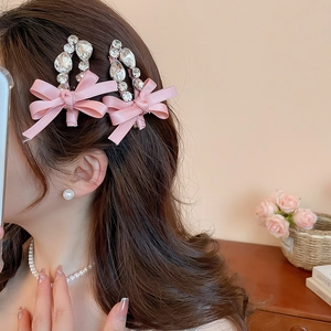 Gros plan de barrettes noeuds roses avec strass portées par un mannequin