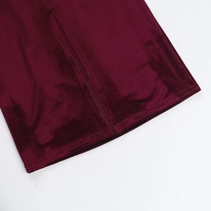 Detail view of burgundy velvet evening dress showing side slit and premium fabric texture