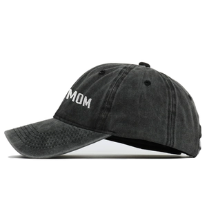 Close-up of high-density white MOM embroidery on vintage washed charcoal baseball cap