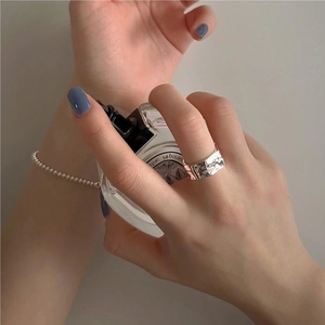 Close-up of S925 sterling silver liquid metal texture ring and beaded chain bracelet