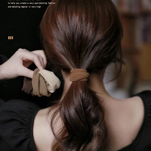 Brown and beige seamless high-elasticity hair ties shown in a ponytail and hand