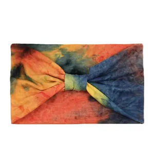 Close-up of tie-dye wide headband with knotted design and vibrant gradient colors
